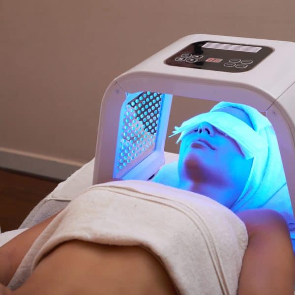 woman has LED light therapy for skin rejuvenation, as part of the VIE AquaFacial