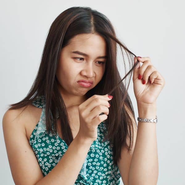 woman suffering from dry, thinning and damaged hair