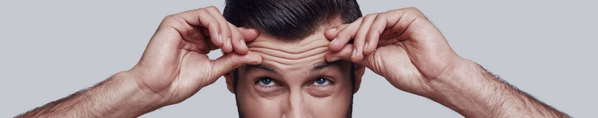 male model demonstrates forehead lines and ageing concerns