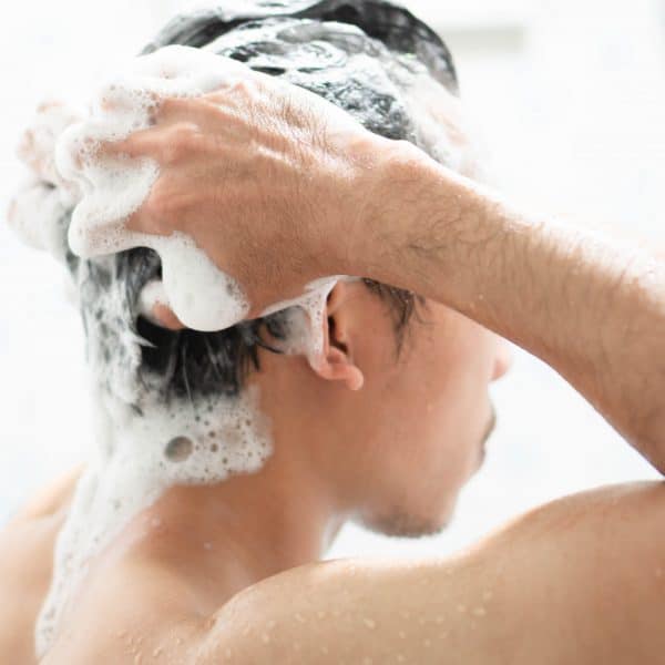 man shampooing worried about hair loss