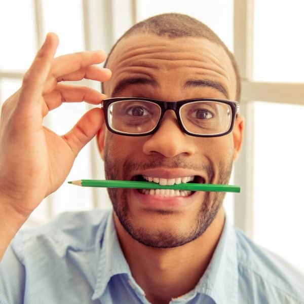 man holding pencil between his teeth to test mood