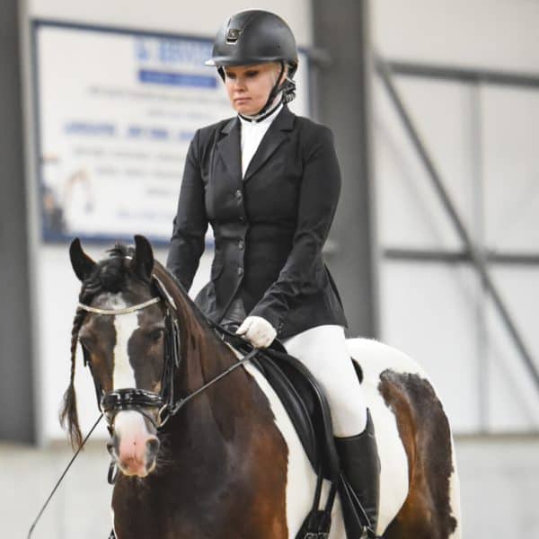 woman horserider competes in a dressage event