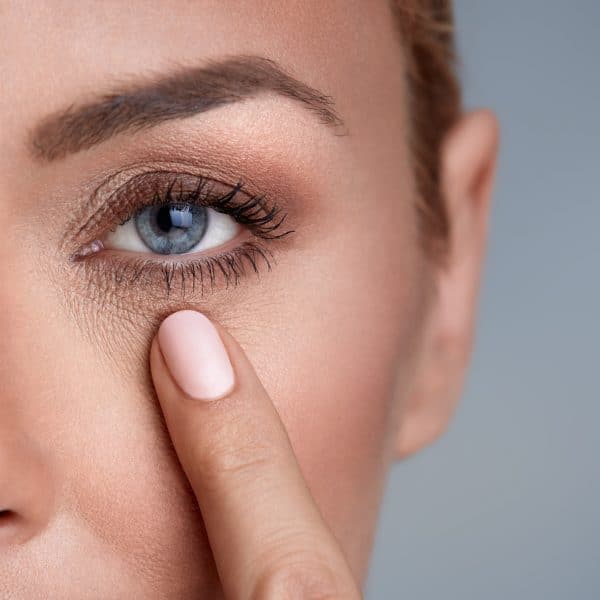 woman checking wrinkles around the eyes