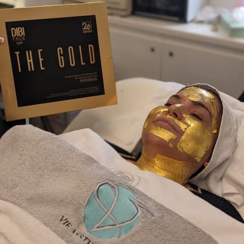 woman has the DIBI 24-Karat Gold Leaf Facial at Vie Aesthetics