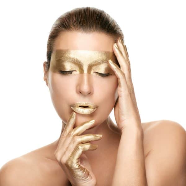 Woman with 24 Karat golf leaf facial for skincare treatment