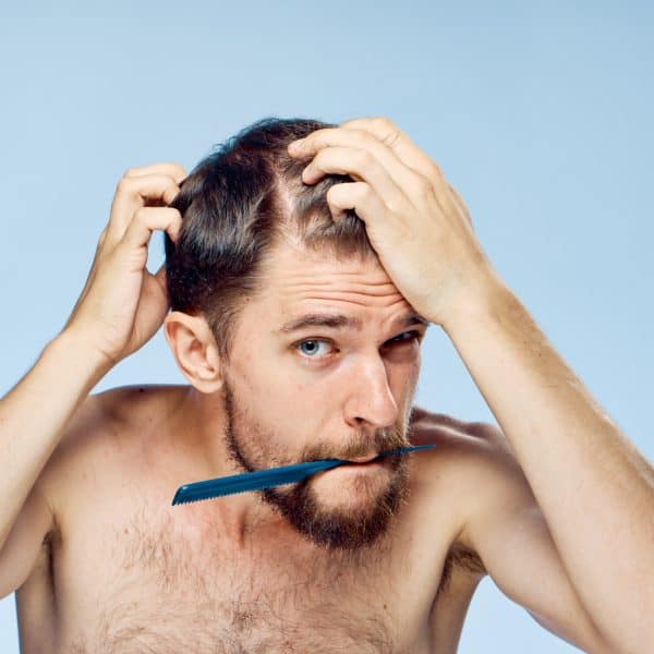 young man noticing early signs of hair loss