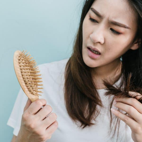 woman wondering what is causing her hair loss